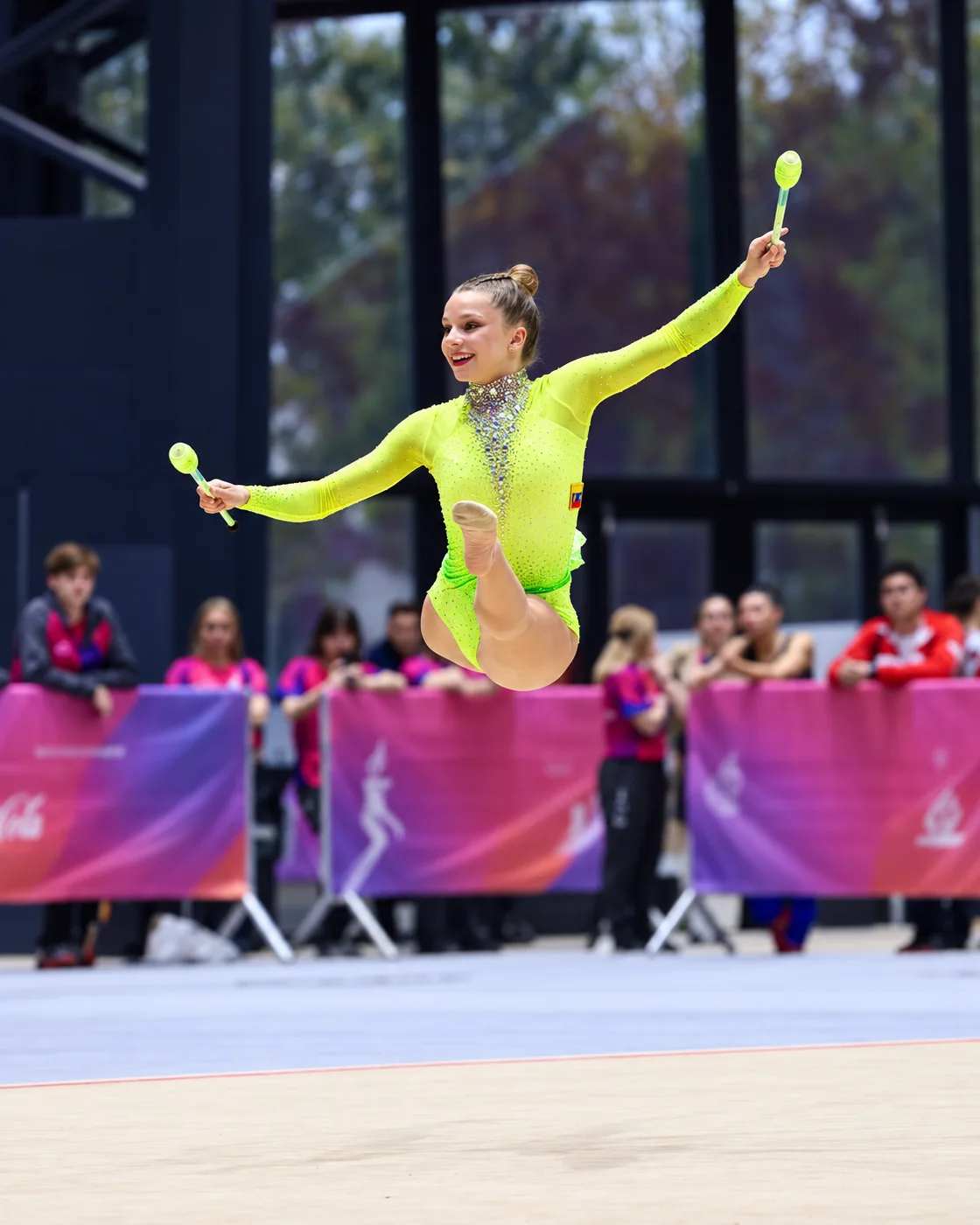 Jimena Dominguez of Rhythmic Art leaping with clubs at the South American Games in Santa Fe